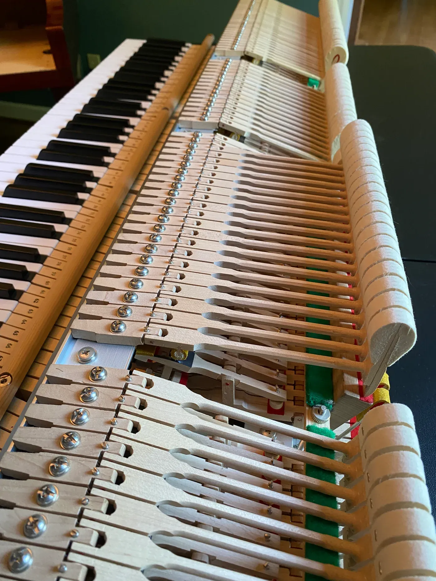 The exposed action and hammers of an upright piano during service